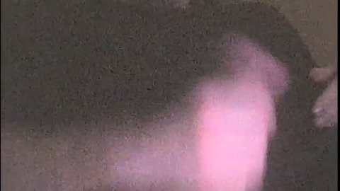 Blurry closeup of pale woman's big pink dildo and hand in solo masturbation