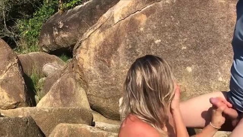 Jane R footjobs cock by rocks outdoors in public sex scene