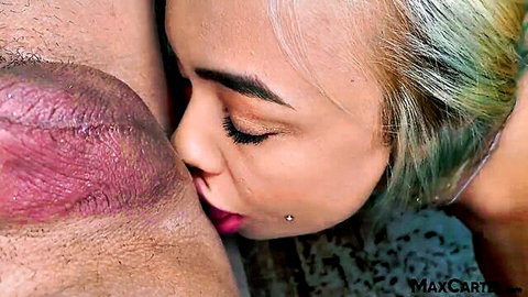 Tattooed blonde with lip piercing kissing erect cock close-up
