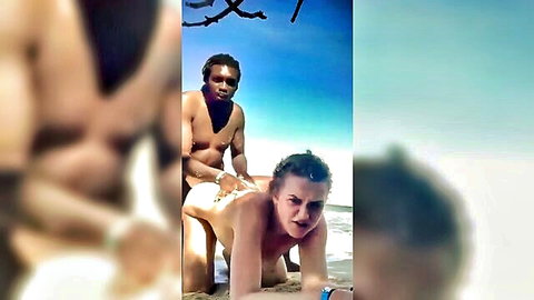 Interracial gay beach sex: black man in doggy style with pale guy