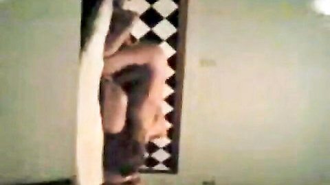 Latina woman in explicit Mexican bedroom doorway pose