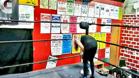 Lady Wasp in tight black catsuit bending over in wrestling ring