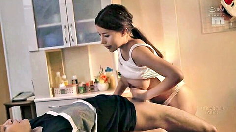 Seductive Asian MILF in tight tank top and panties massages man with big tits