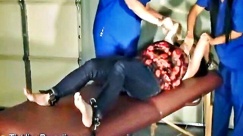 Restrained woman in jeans gets ticklish foot massage with shackles