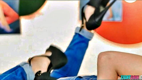 Sexy amateur babe's bare thighs and legs in black high heels with rolled-up blue jeans by pool