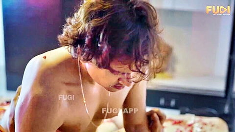Shirtless wavy-haired Indian man drooling while licking pussy on red bed sheets