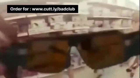 Desi Indian man in store holding brown sunglasses, amateur vibe
