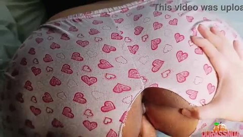 Closeup of woman's big heart panties pulled aside exposing ass grabbed by hand
