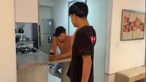 Two hot Latino guys bare-chested in kitchen, sneaky cheating vibes