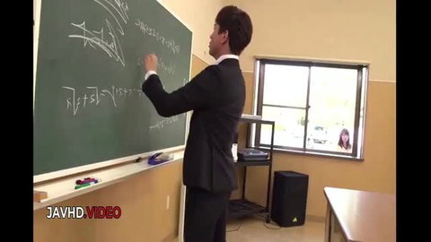 Asian male teacher writing on chalkboard in JAV school scene