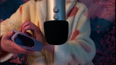 ASMR girl with purple toy and studio mic, cozy setup