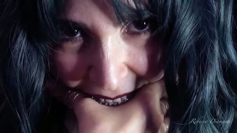 Rebecca Diamante biting fingers with dark lipstick and green hair