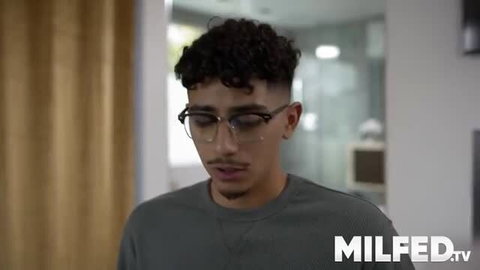 Young man with glasses and curly hair in adult scene