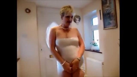 Horny mature housewife with short blonde hair in revealing white outfit