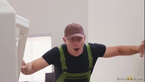Startled handyman in green overalls and cap caught by surprise