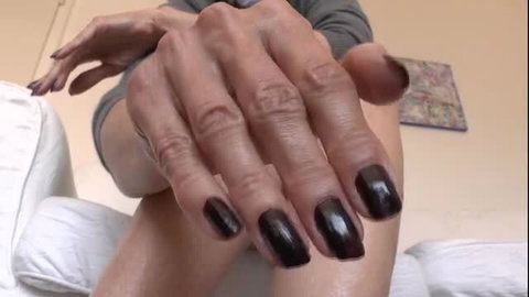 Lady Victoria Valente with glossy black nail polish showing shiny bare legs