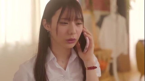 Yuka Miyoshi on phone call wearing white shirt, long dark hair