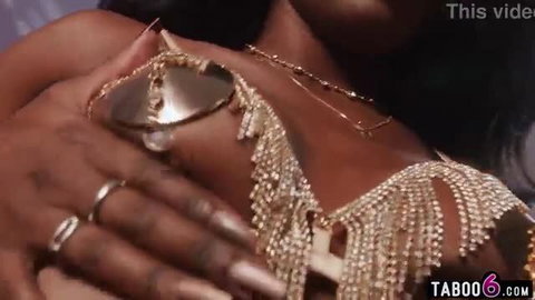 Ana Foxxx in gold body jewelry with nipple pasties and hand on breast