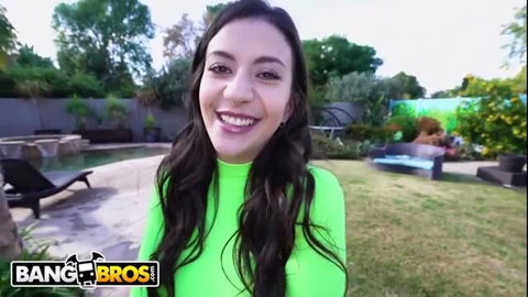 Natalie Brooks smiling in neon green outfit, outdoor pool background