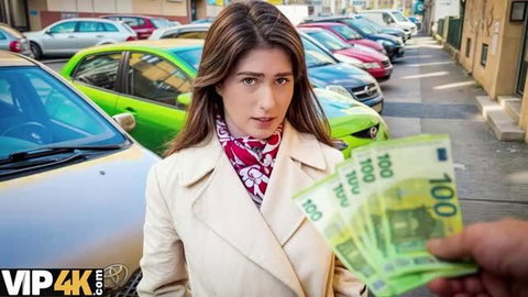 Pearl in beige coat receiving cash from man on street