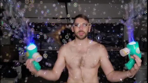 Shirtless muscular man playing with glowing bubble guns, shirtless hairy chest
