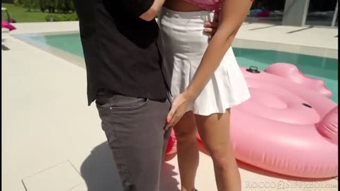 Rocco Siffredi and bikini woman in white skirt poolside handjob scene