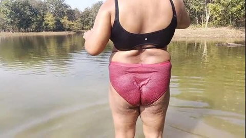 Desi woman in wet pink panties standing in forest river