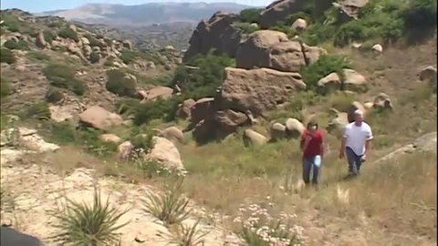 Flower Tucci in red top hiking rocky desert trail outdoors