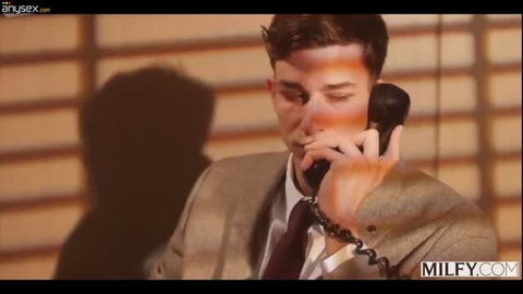 Parker Ambrose in suit with beaded bracelet on phone call