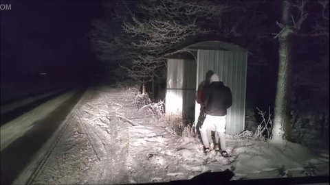Man in white shorts with woman by the road at night