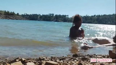 Angolan woman topless in water outdoors, explicit adult scene