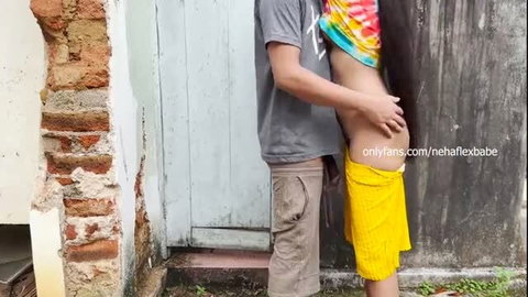 Man groping woman in revealing yellow outfit from behind outdoors