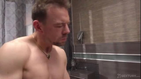 Cherry Kiss gives handjob to muscular man in bathroom scene