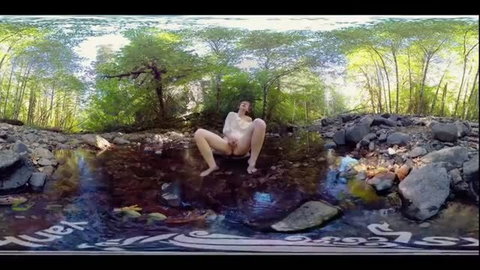 Redhead Carmen December masturbates in forest stream