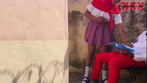 Schoolgirl in plaid skirt and red scarf teases man in red pants
