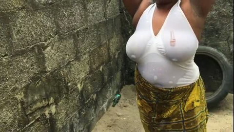 Busty African woman in sheer white top, outdoor Naija porn thumbnail