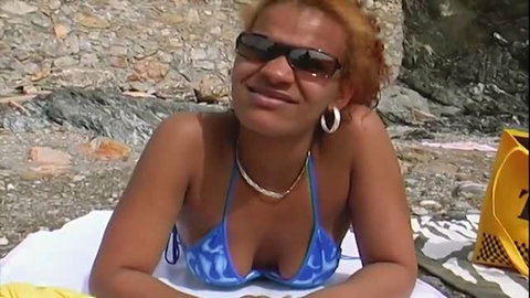 Horny ebony woman in blue bikini on beach ready for oral sex