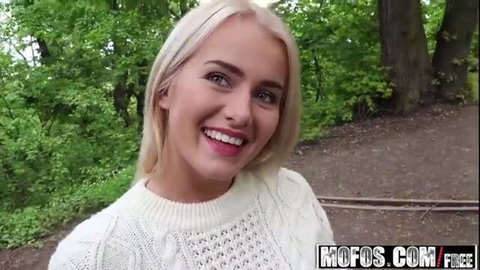 Smiling blonde in white sweater outdoors, Aisha from Public Pickups