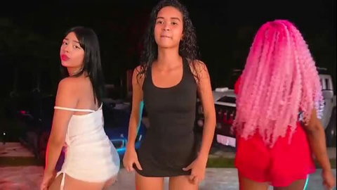 Three women in tight dresses at night, outdoor party vibe