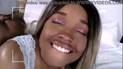 Nina Rivera smiling during interracial sex scene in bed