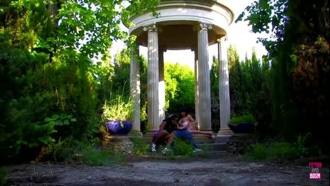 Two couples having outdoor sex in garden gazebo with natural lighting