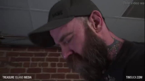 Jack Dixon in green cap, close-up profile with neck tattoos