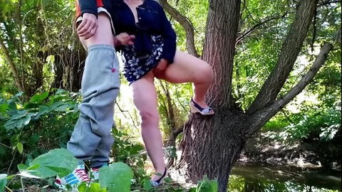 Mature busty MILF in dress fucks outdoors against tree