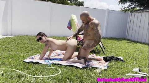 Tattooed woman gets fucked outdoors by muscular stepdad on lawn