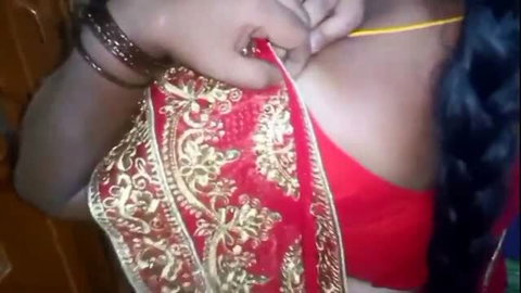 Indian housewife adjusting red saree over blouse