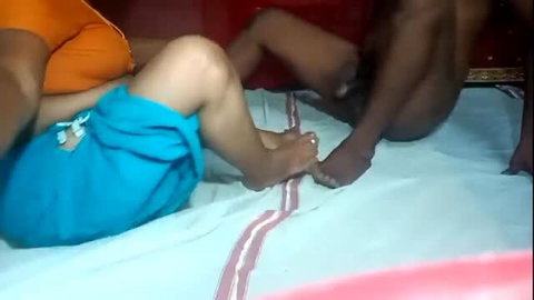 Indian wife in orange top and blue shorts gets fucked by friend on bed