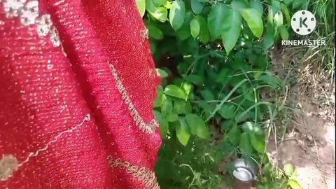 Red sari woman in garden, outdoor seduction scene