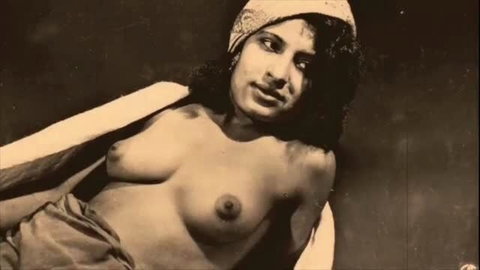 Vintage nude woman topless with headscarf, classic erotic portrait