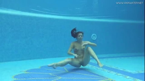 Nude MILF posing underwater in pool, wet body and dark hair