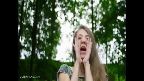 Stephanie Moon moaning outdoors with hands on cheeks, surprised expression